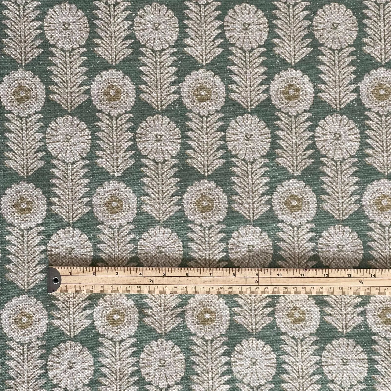 Decorative green floral fabric with structured folk pattern layout