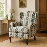 Thumbnail for Decorative armchair with leaf pattern in a room with a lamp and cabinet.