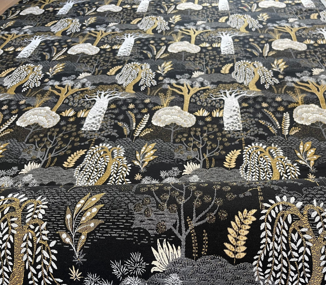 Fabric roll of Baobab Botanical black and gold textile.