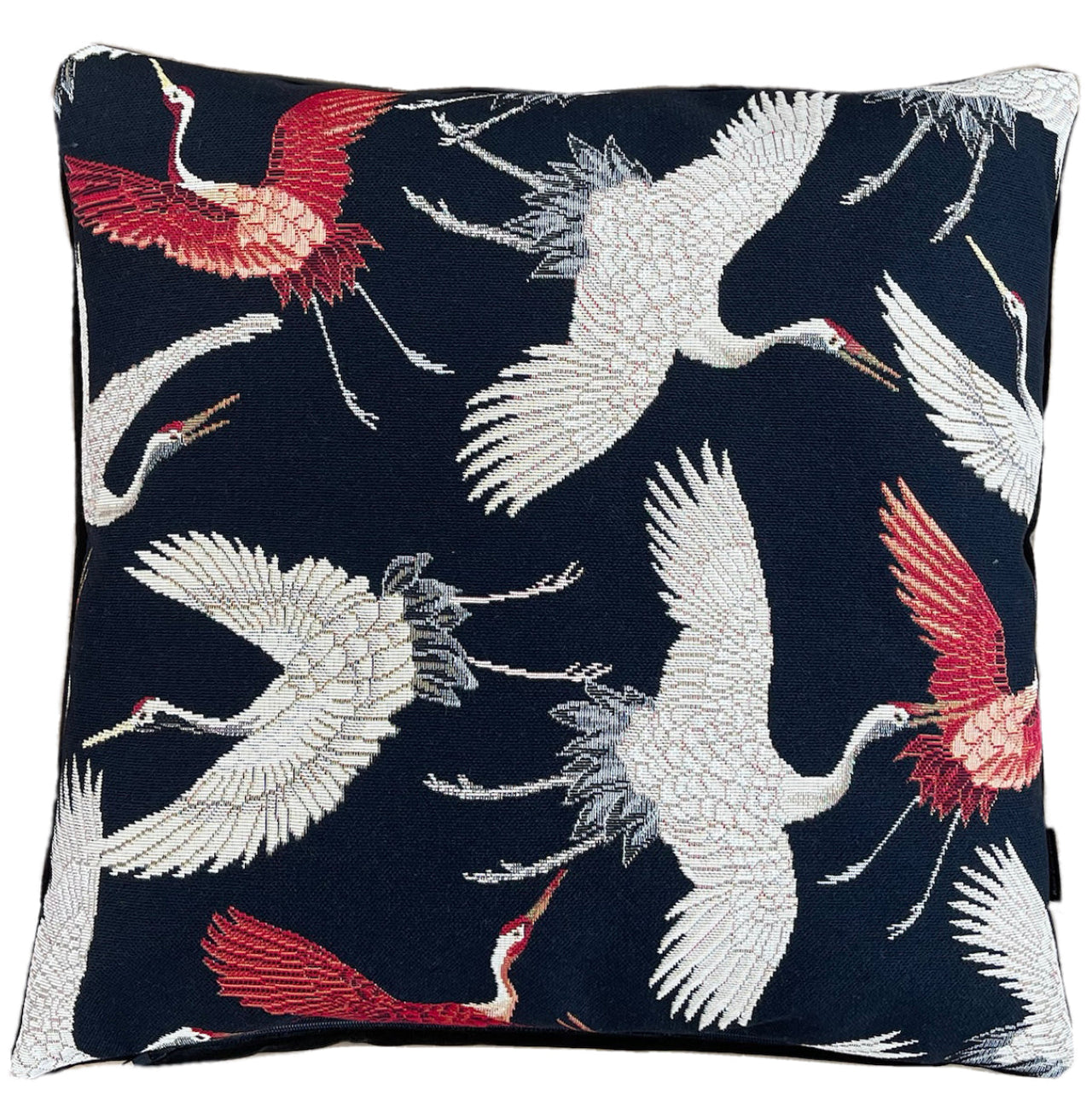 Decorative black pillow with flying birds design.