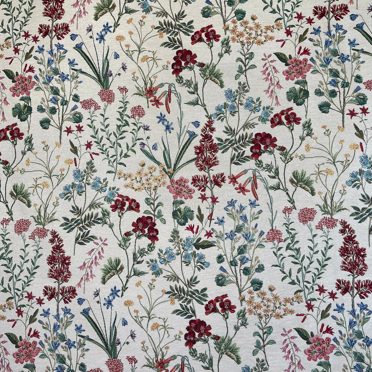 Floral patterned fabric with red, blue, and green flowers on a white background