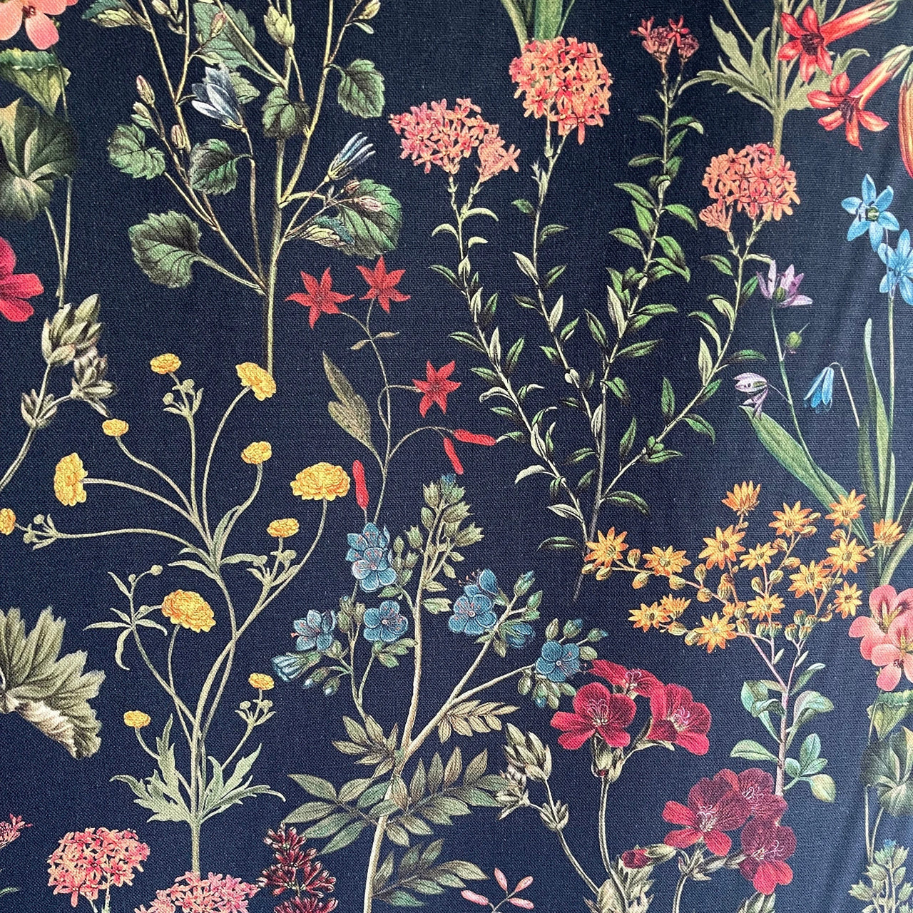 Navy blue fabric with colorful floral pattern