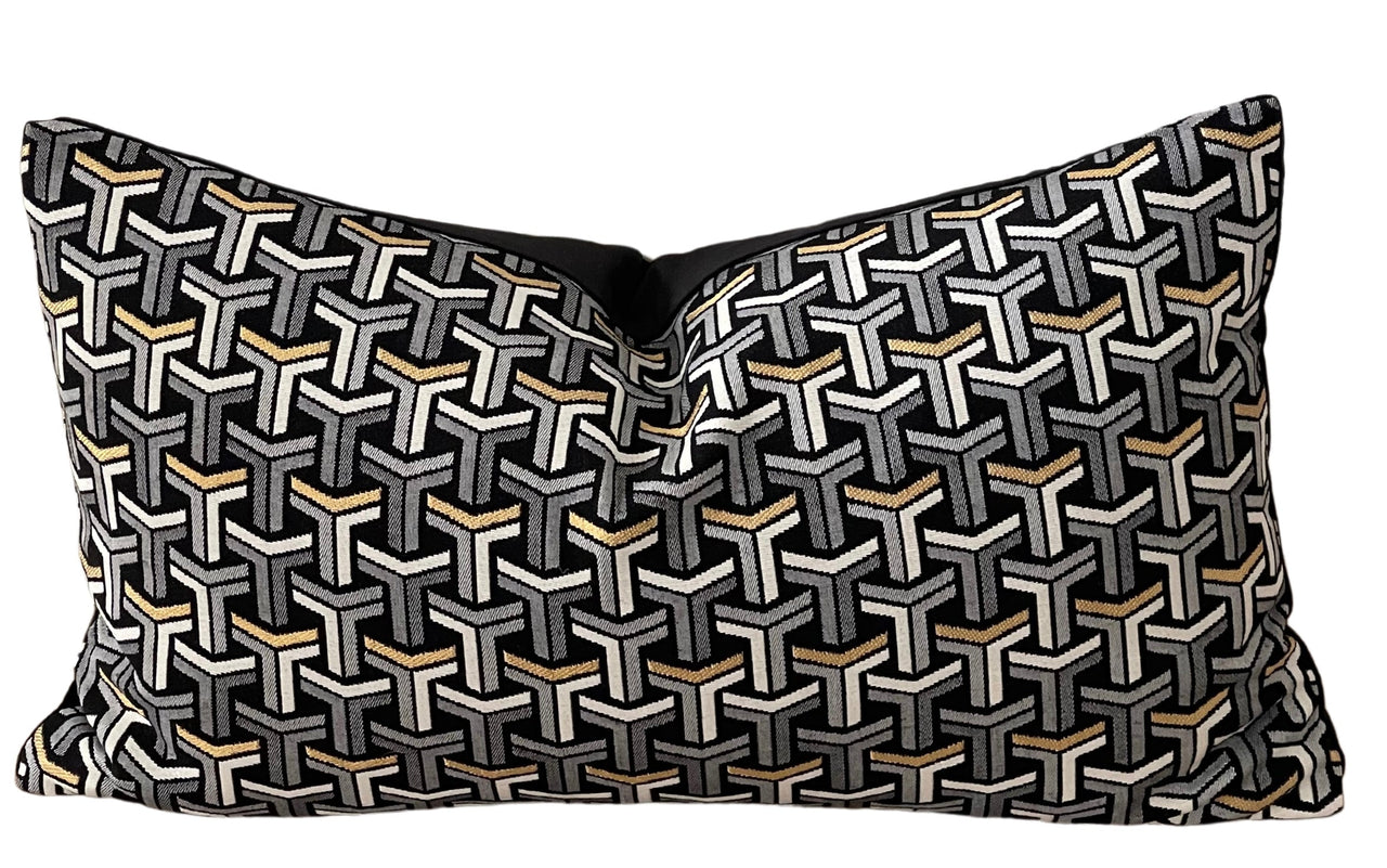 Striped geometric cushion with metallic finishes.