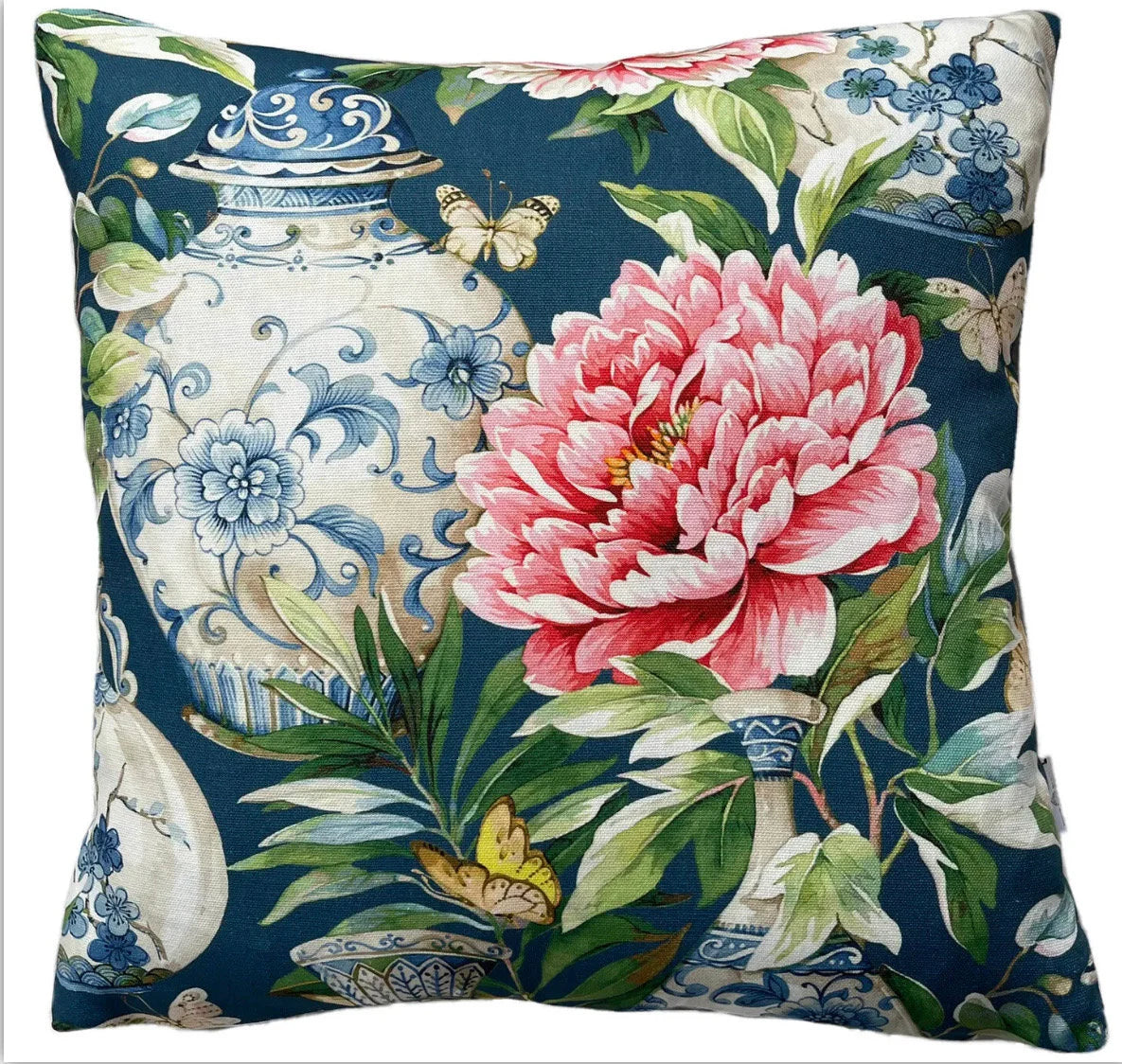 Jardine pattern cushion cover with detailed blue and white vases, soft pink flowers, and lush green foliage on a rich blue background.

