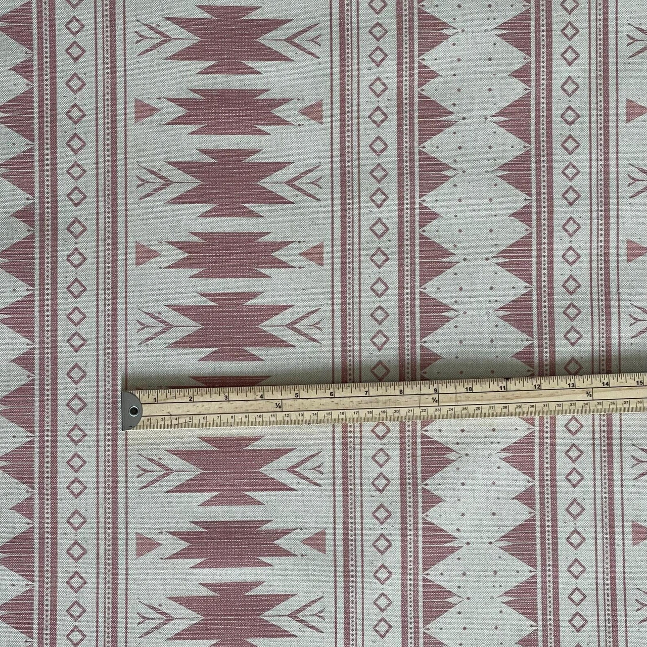 Natural linen base fabric with blush pink tribal design and soft texture