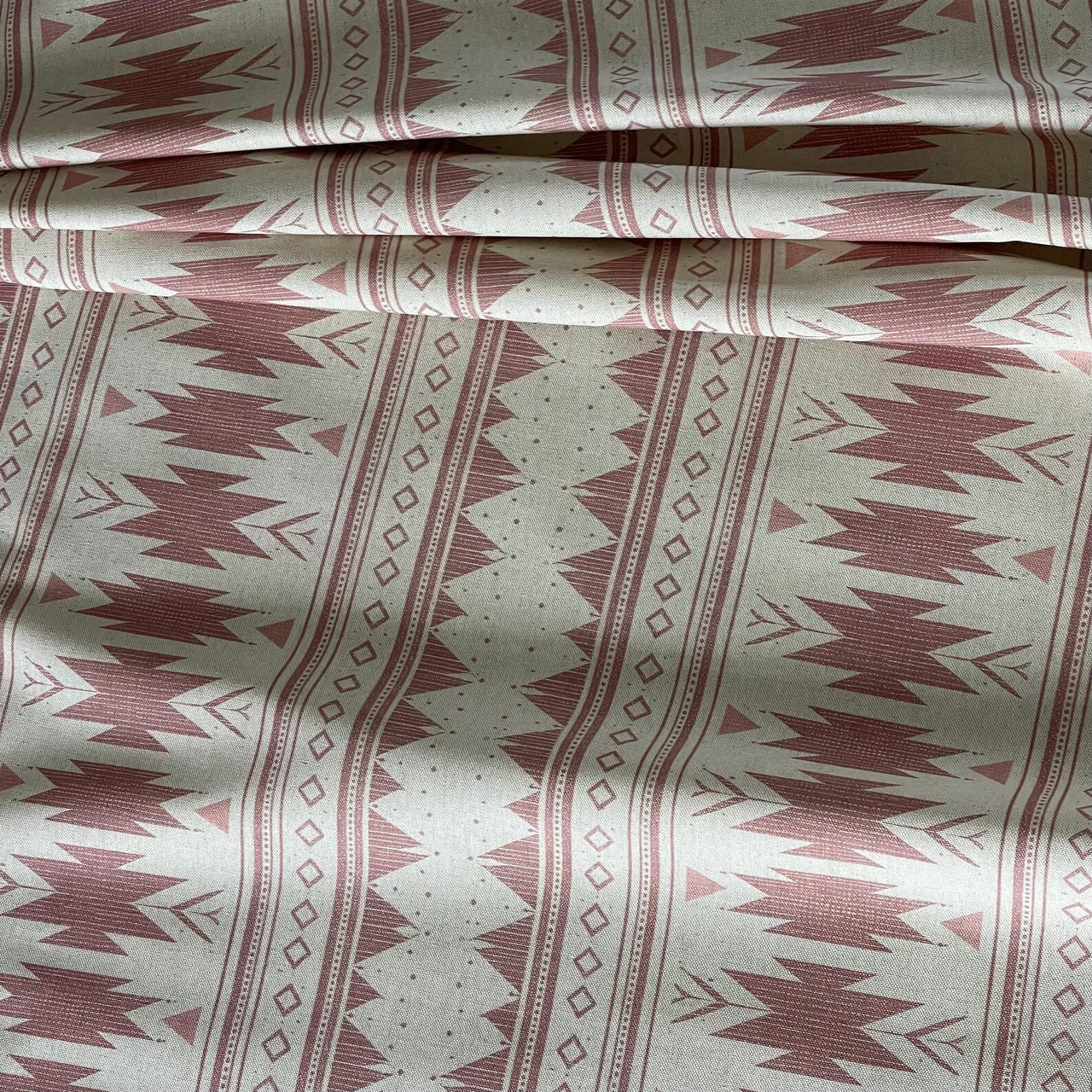 Boho tribal fabric blush pink with repeating geometric motifs and natural base