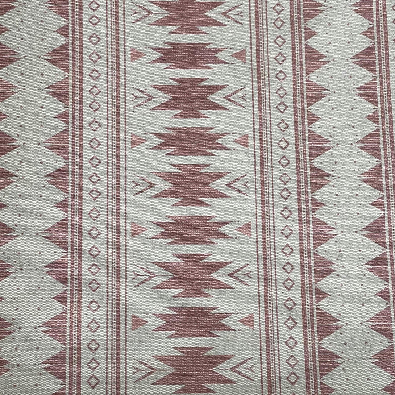 Aztec stripe fabric in blush pink tones with diamond and arrow motifs