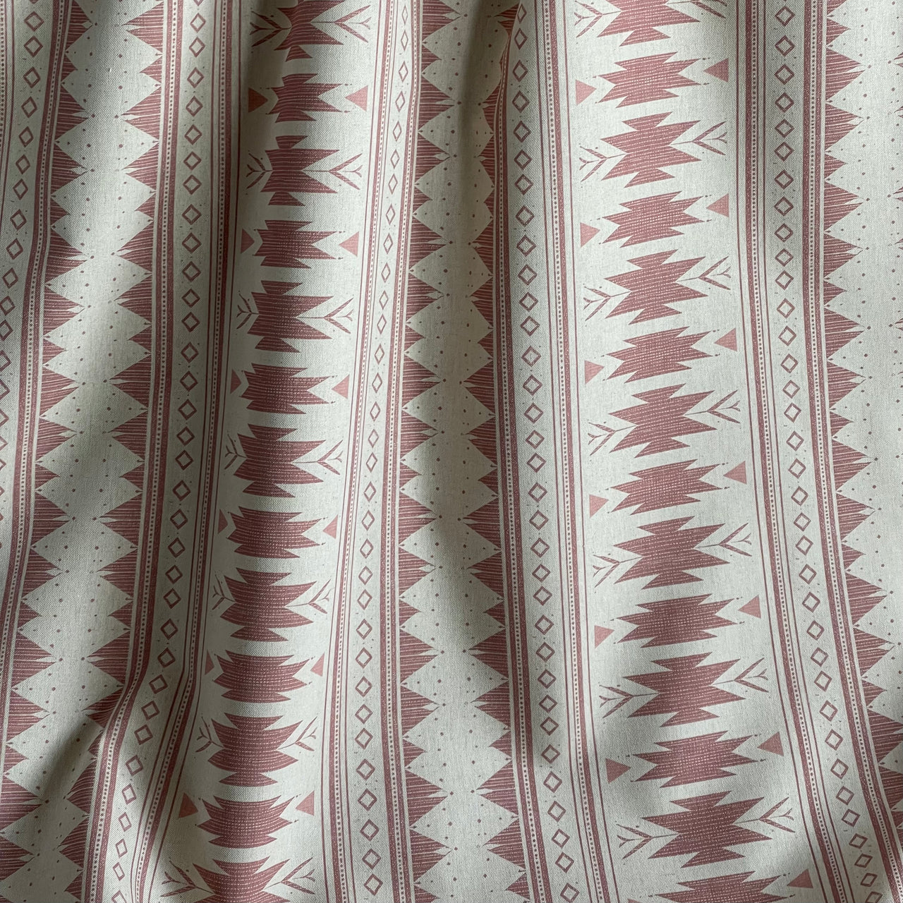 Aztec stripe fabric blush pink with diamond and arrow motifs