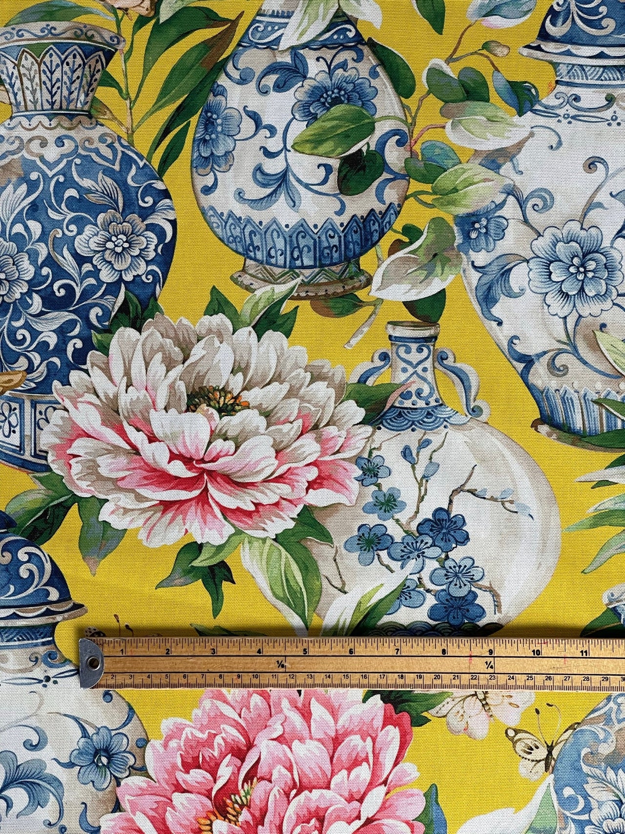 Yellow floral fabric with Ming vase and pink peony print in close-up