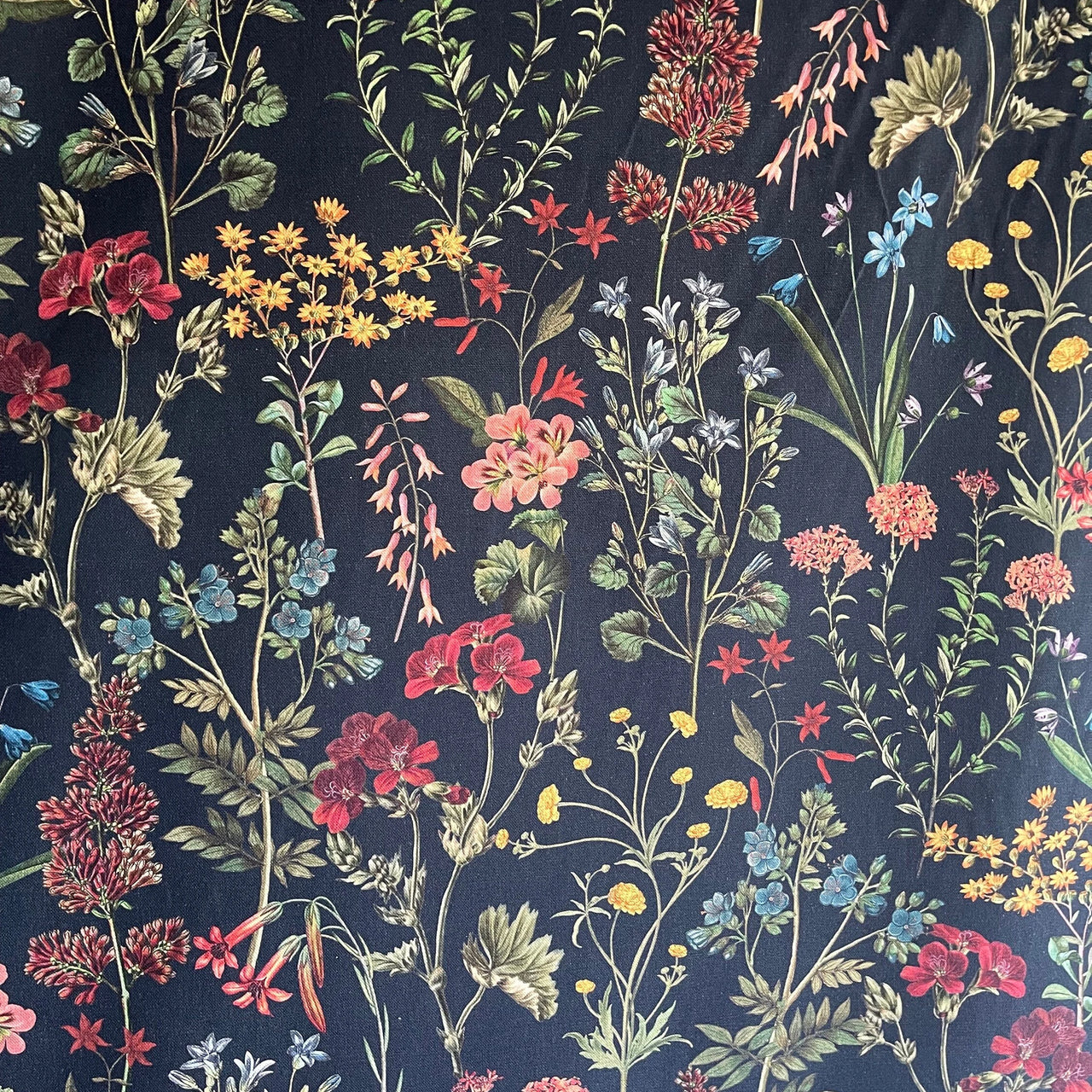 Pattern of colorful flowers and leaves on a dark background