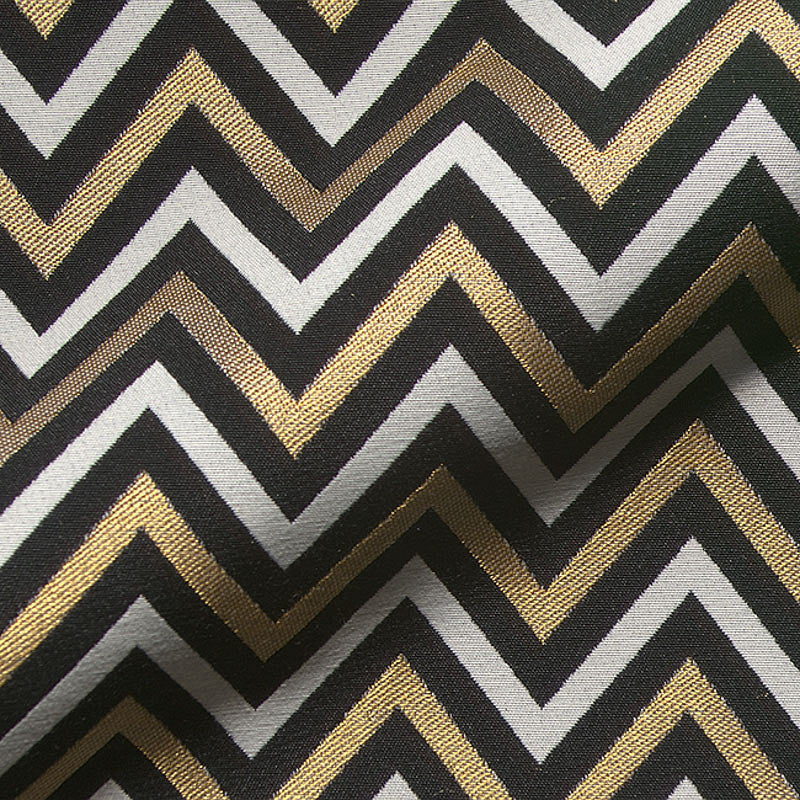 Modern gold and black chevron fabric texture.