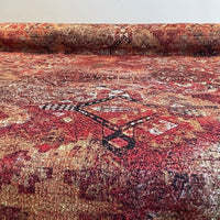 Thumbnail for Roll of patterned red and brown fabric with a visible brand logo.