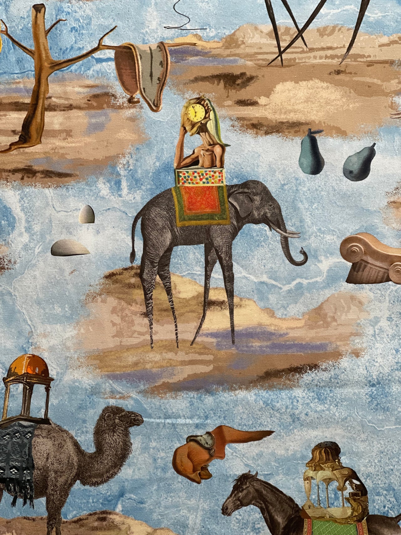 Blue surrealist animal print fabric showing its repeating elephant, camel and horse motifs, with a 67cm pattern repeat.
