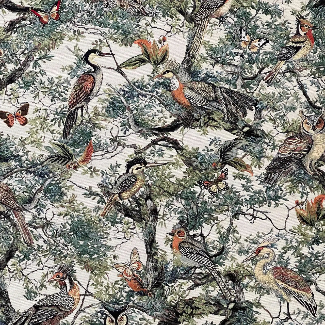 Woodland tapestry fabric featuring woven birds and butterflies in forest foliage.