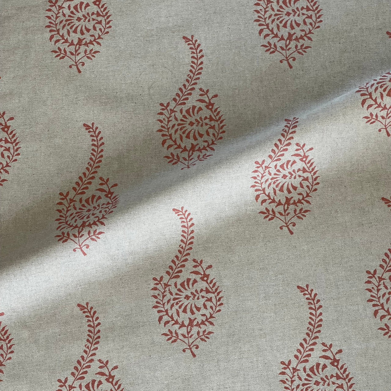 Indian paisley sprig buta fabric in coral on beige background