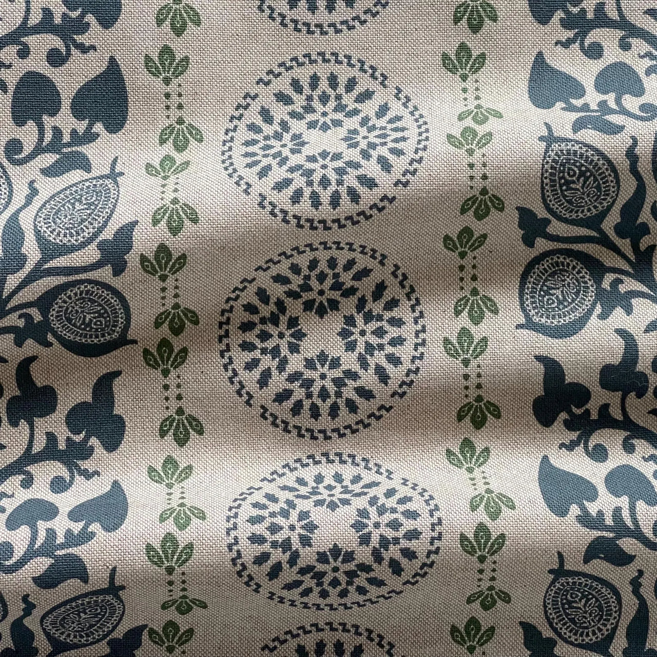 Decorative navy botanical fabric with repeating medallion circles and leaf motifs