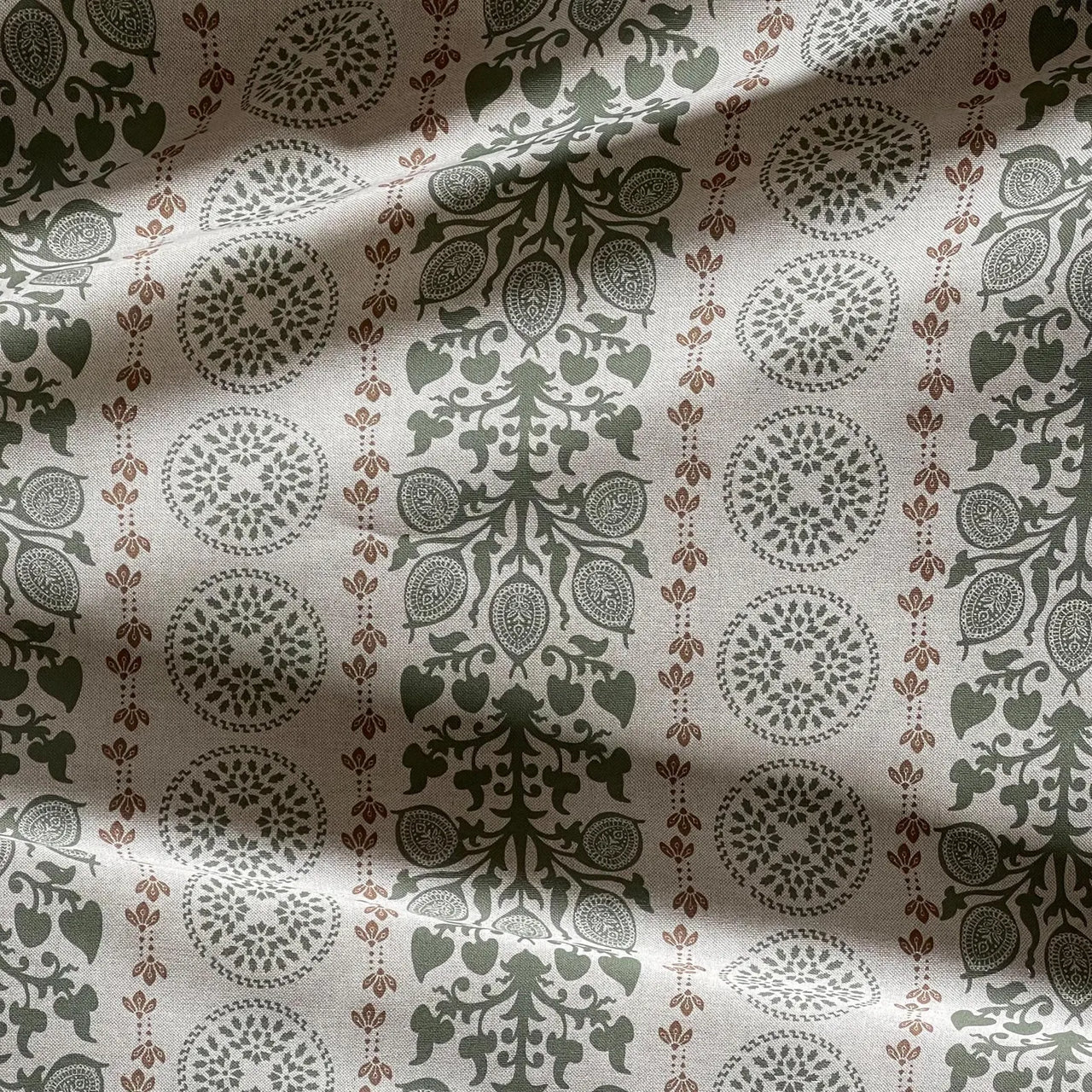 Farmhouse style fabric with sage green floral motifs and heritage pattern