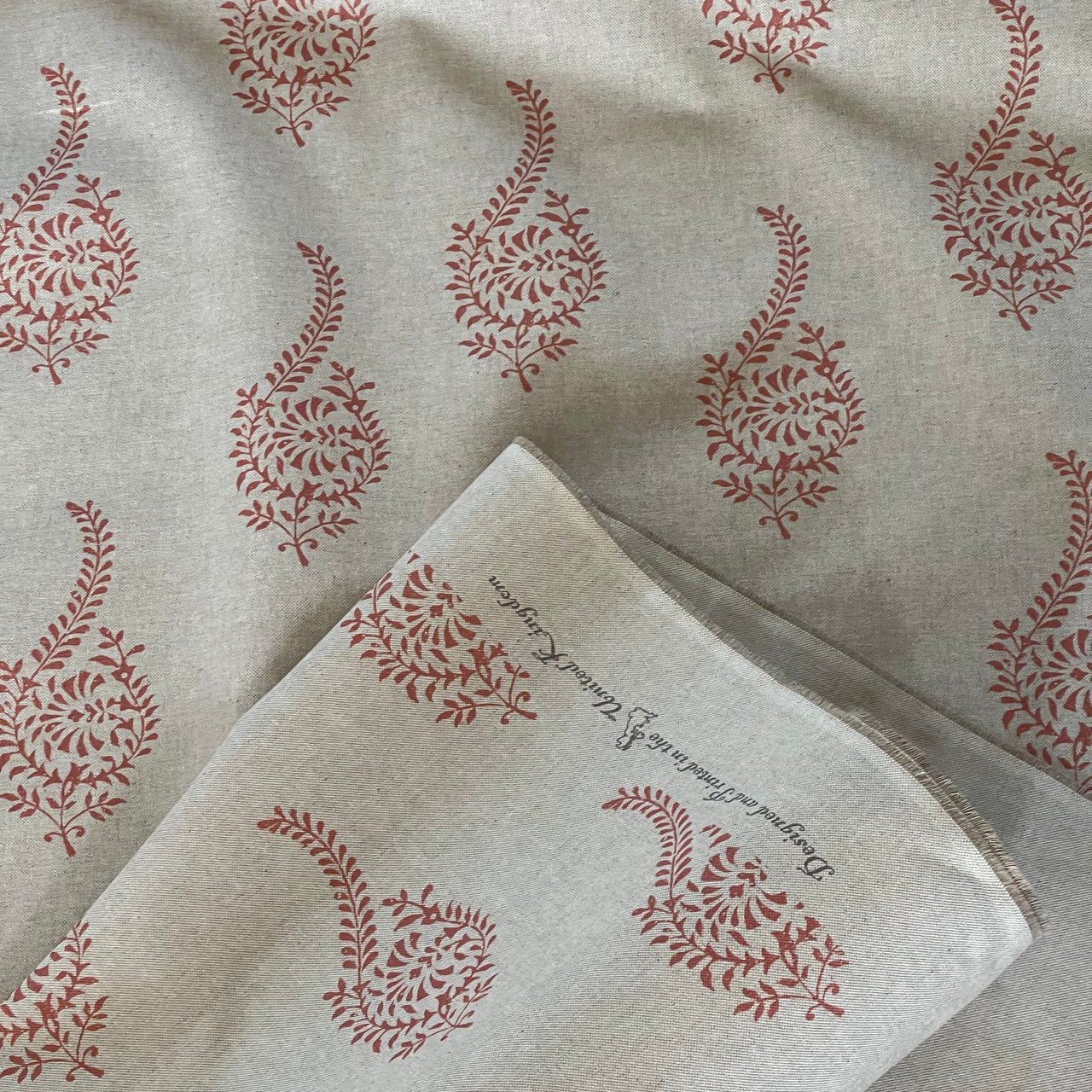 Coral block print fabric detail on beige base