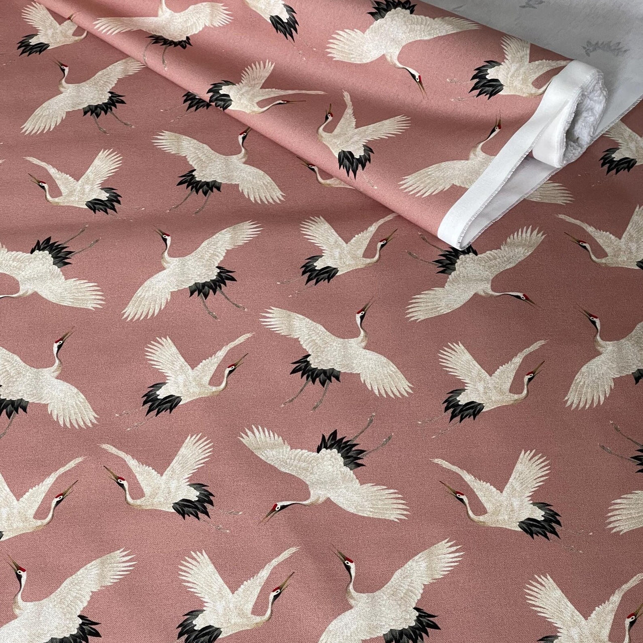 Lightweight cotton fabric with serene flying crane design.