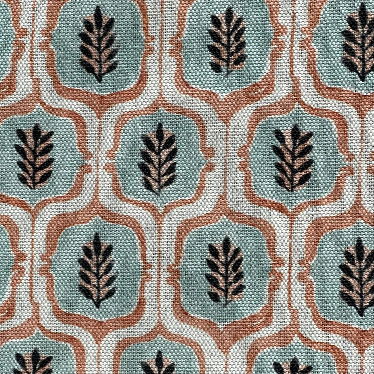 Soft teal medallion fabric with rust trellis details.