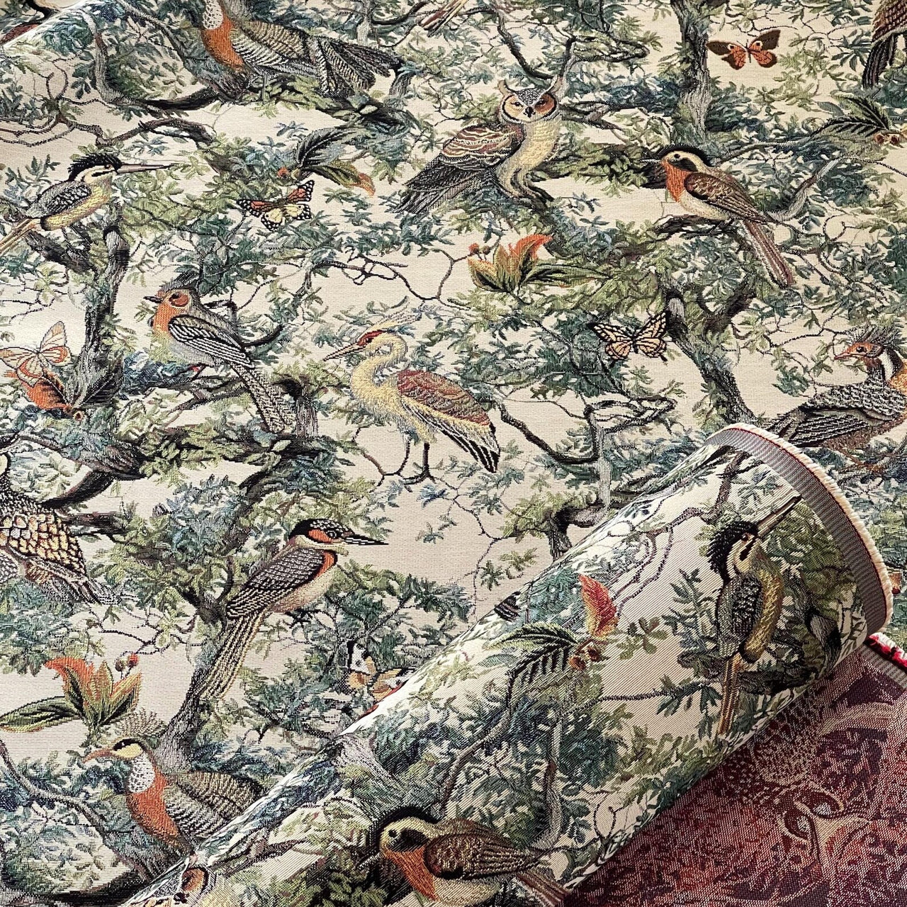 Patterned fabric with birds and nature design on a beige background