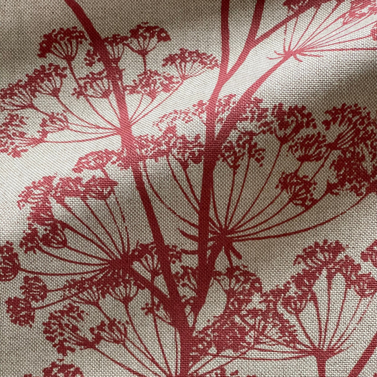 Red floral fabric with detailed cow parsley stems and natural texture