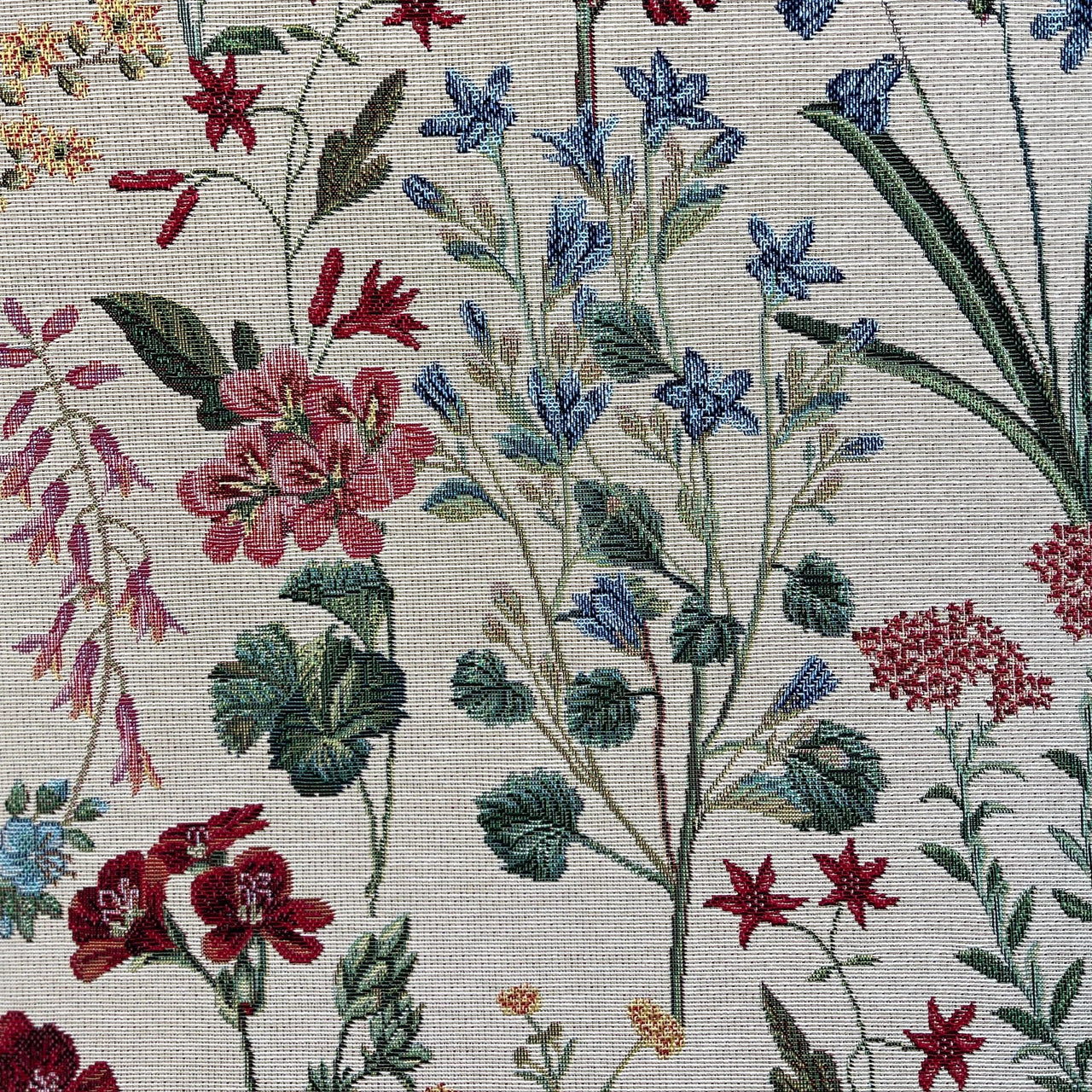 Close-up of a floral pattern with red, blue, and pink flowers on a light background