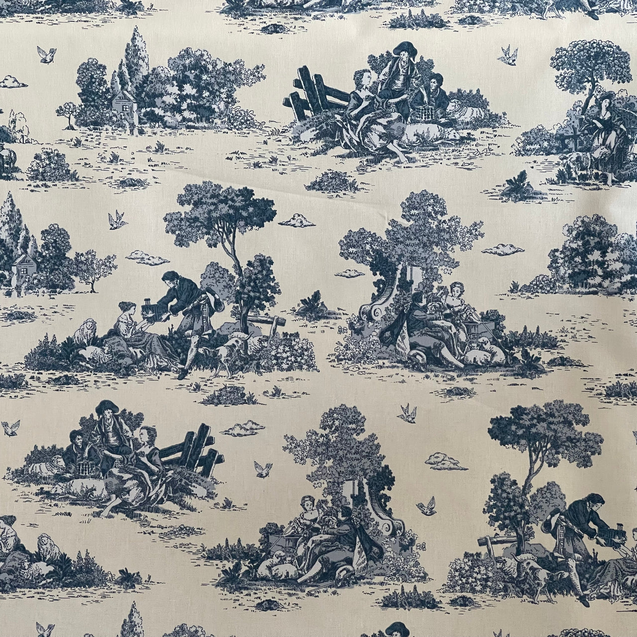 Patterned fabric with black and white design of people and nature on a beige background