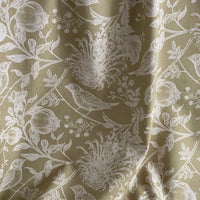 Thumbnail for Floral patterned fabric with white flowers and leaves on a beige background