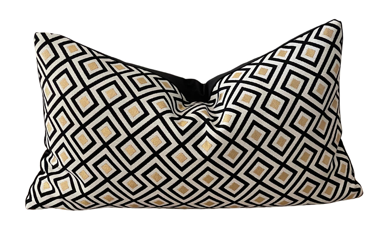 Black, white, and gold woven pillow cover.