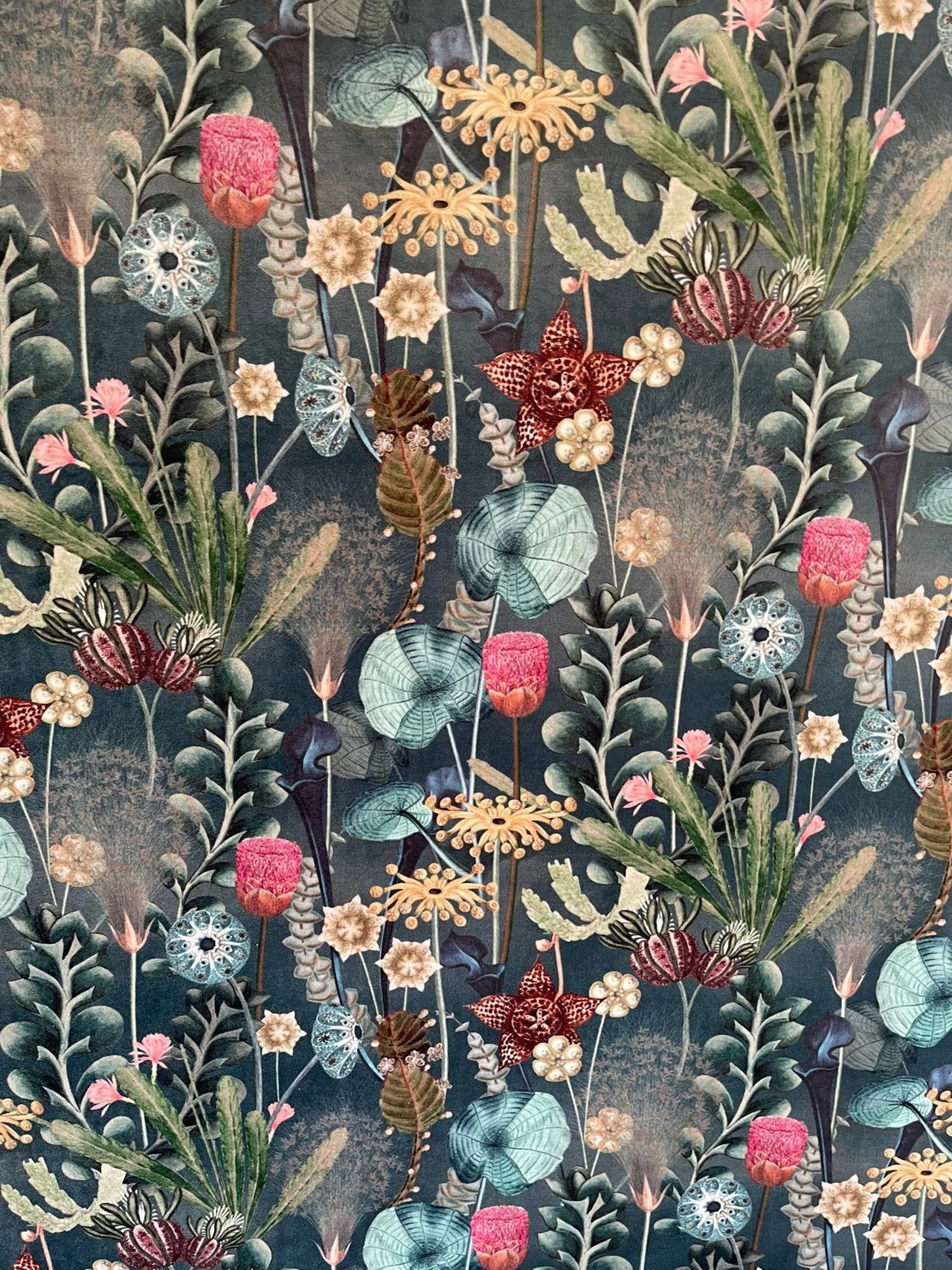 Detailed floral pattern with various flowers and leaves on a dark background