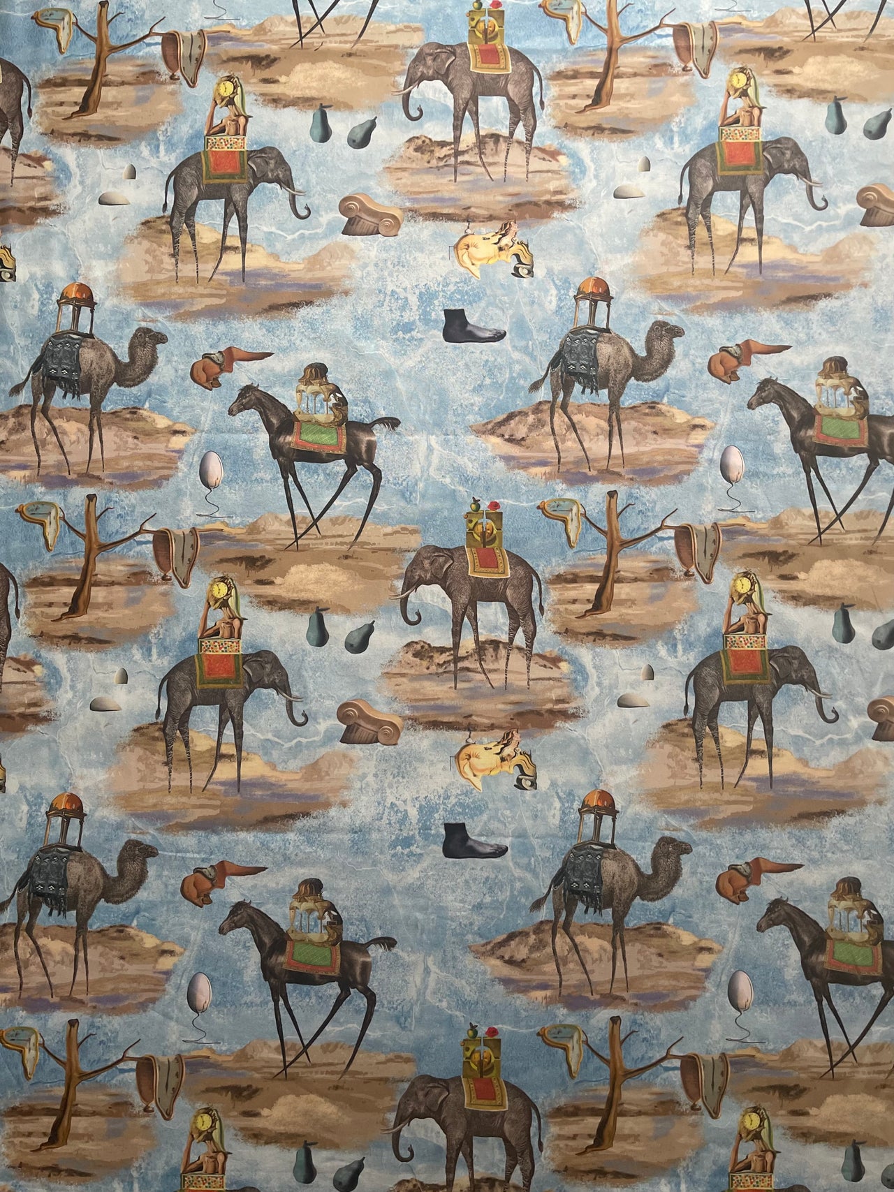 Detailed photograph of horse illustrations on blue surrealist cotton fabric with artistic scenery and contrasting earthy colours.