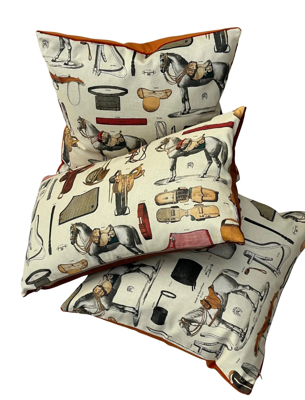 Lifestyle shot: equestrian cushions on sofa and armchair beneath horse painting.
