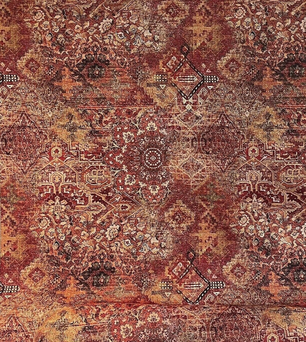 Patterned fabric with intricate designs in red, brown, and beige tones.