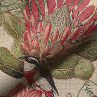 Thumbnail for Close-up of botanical woven fabric with birds and flowers.