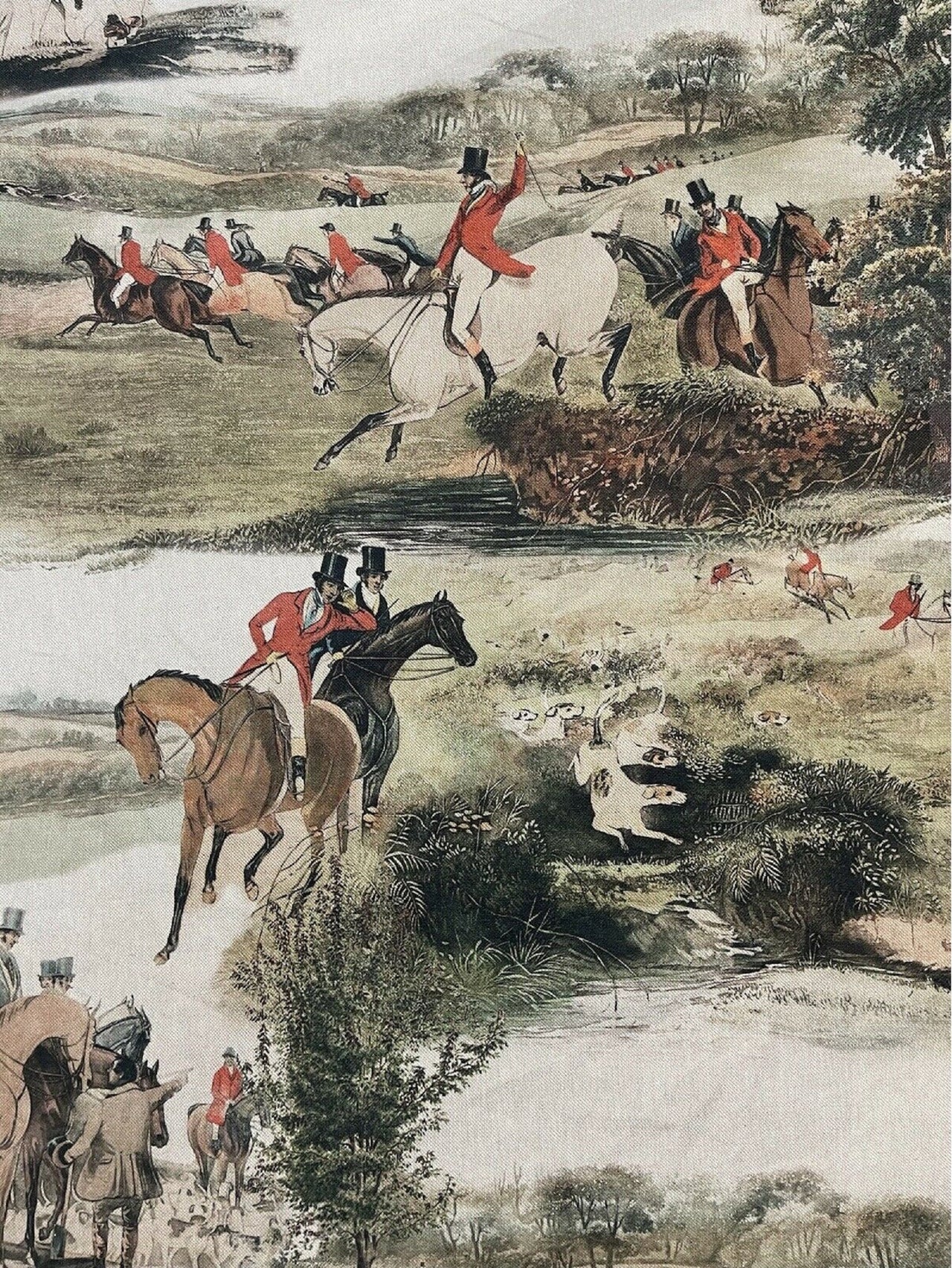 Printed cotton fabric with fox hunt with hunters on horseback in a rural setting.