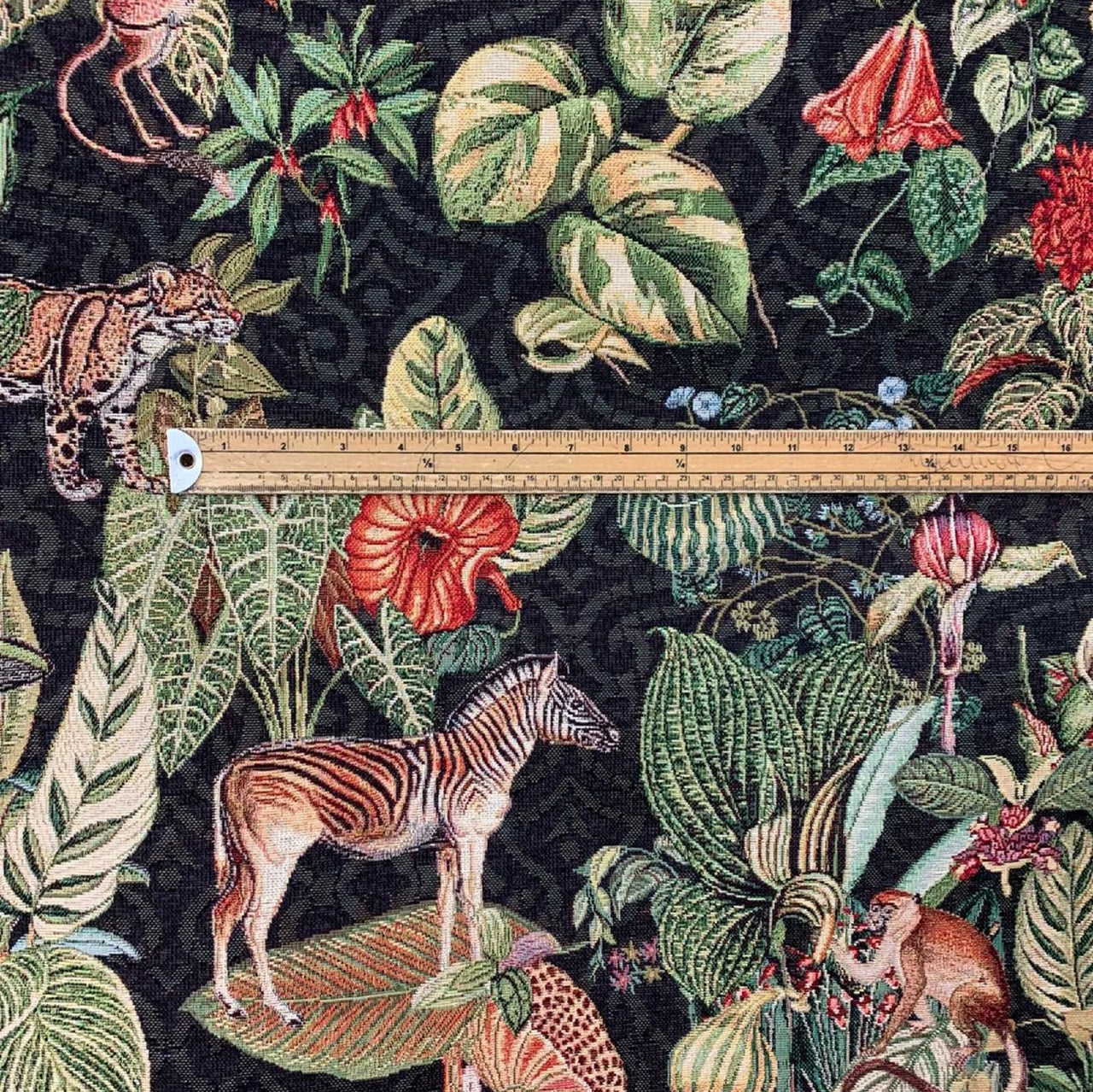 Jungle Kingdom fabric with lush green leaves.

