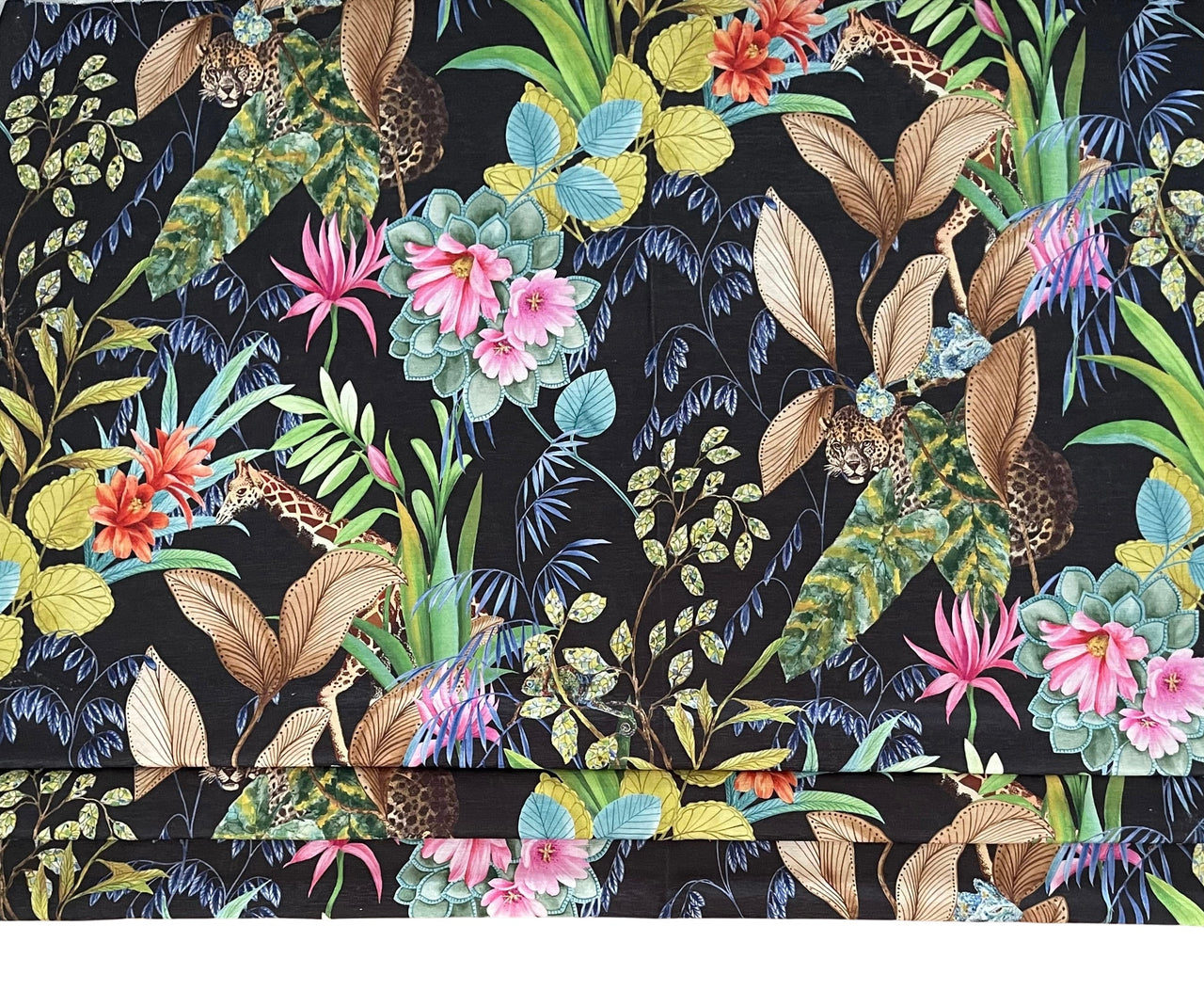 Tropical botanical print fabric with green leaves and flowers.
