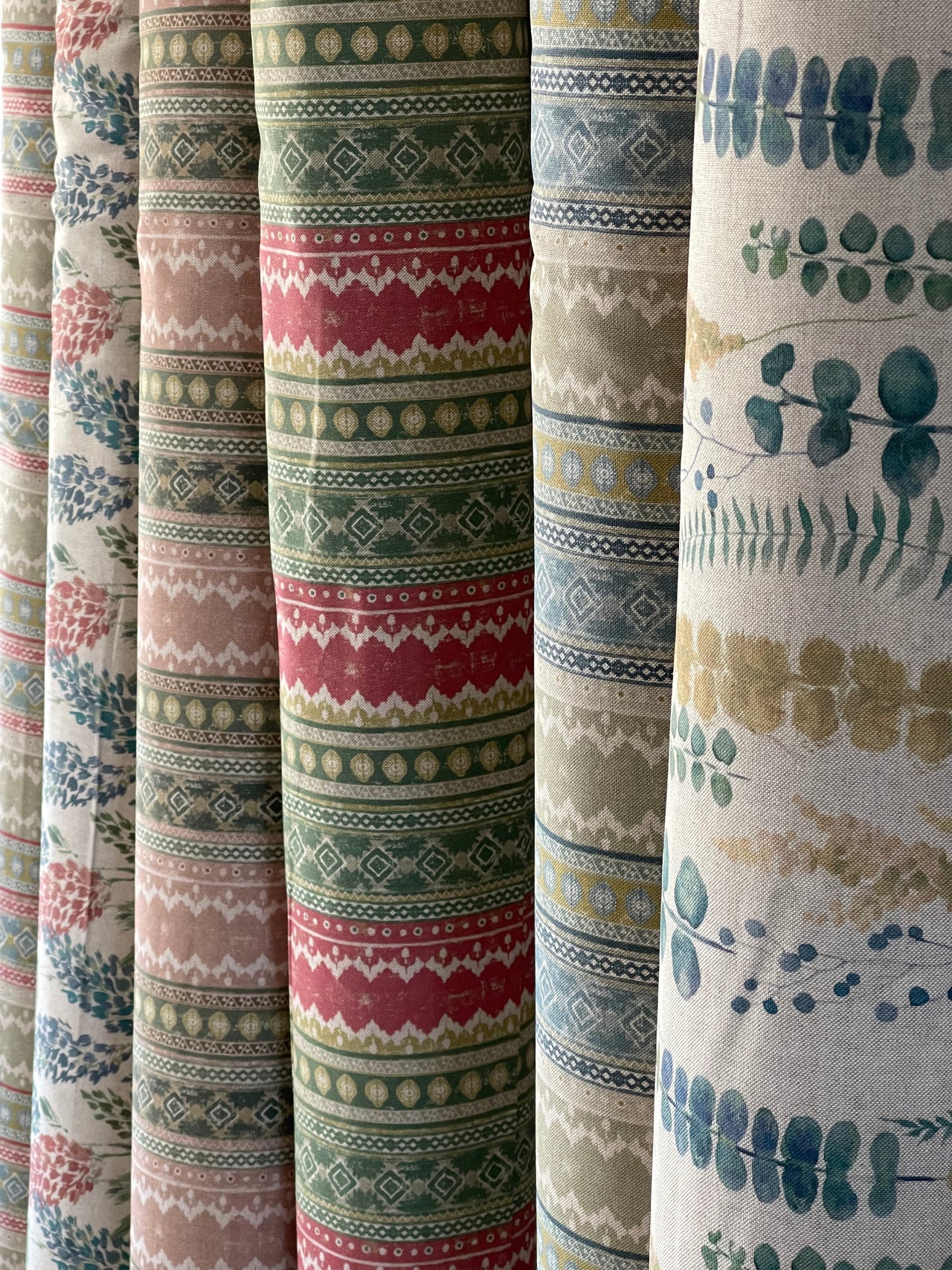 Collection of fabric swatches with various patterns and colors.