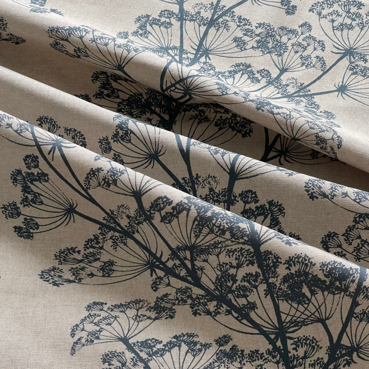 Natural linen look fabric with blue floral botanical pattern repeat