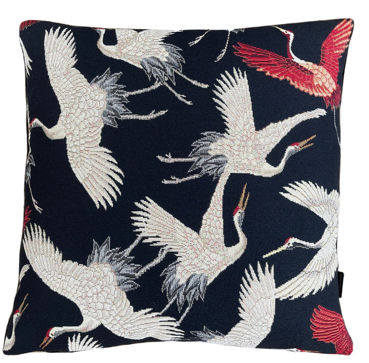 Red and beige crane pattern on throw pillow.