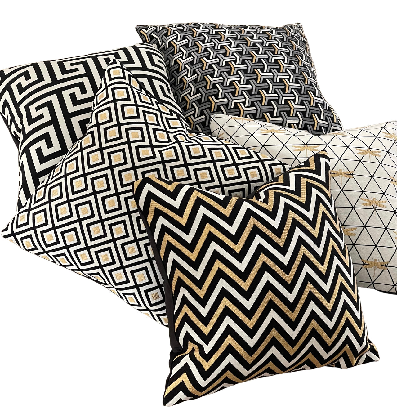 Woven zig zag pillow with black, white, and gold pattern.