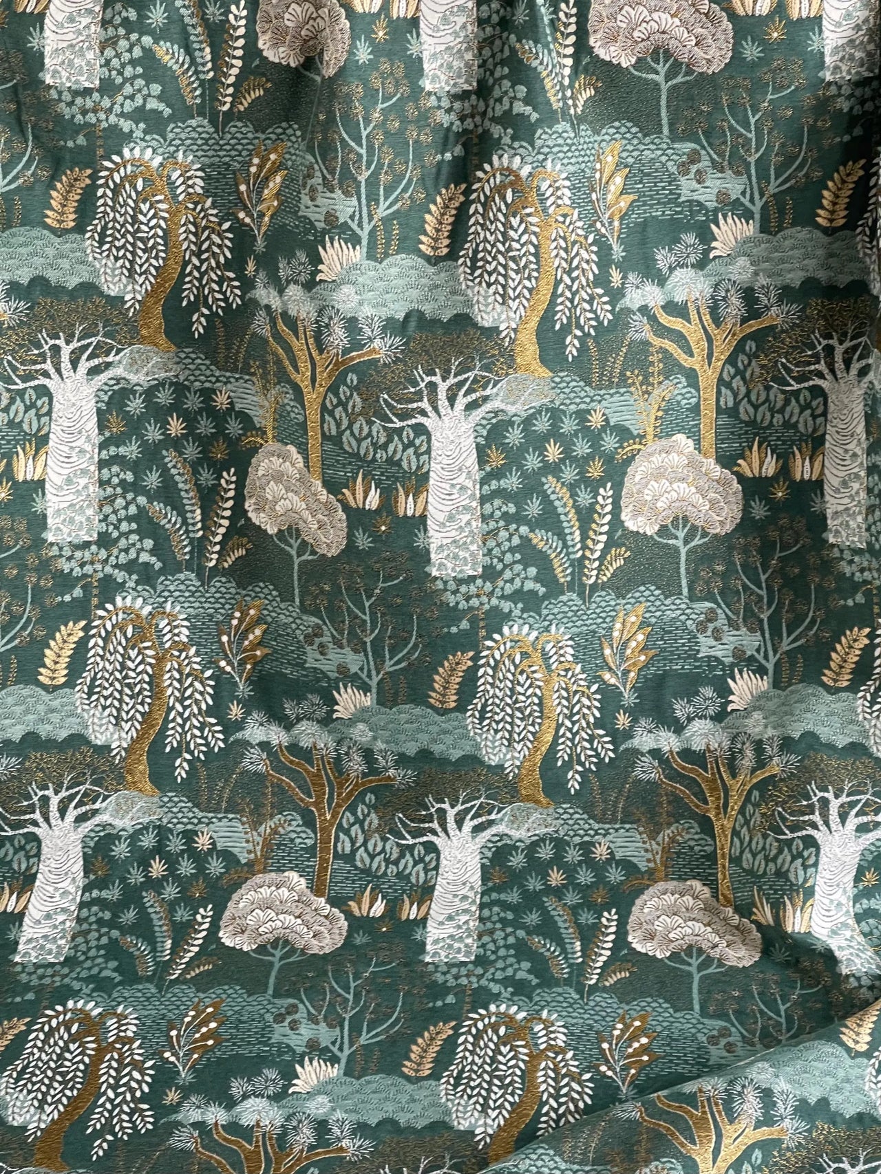 Decorative woven fabric featuring baobab trees and foliage pattern