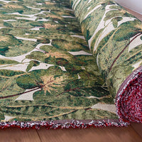 Thumbnail for Rolled tropical leaf patterned woven fabric showcasing texture, fringe, and vibrant green botanical design