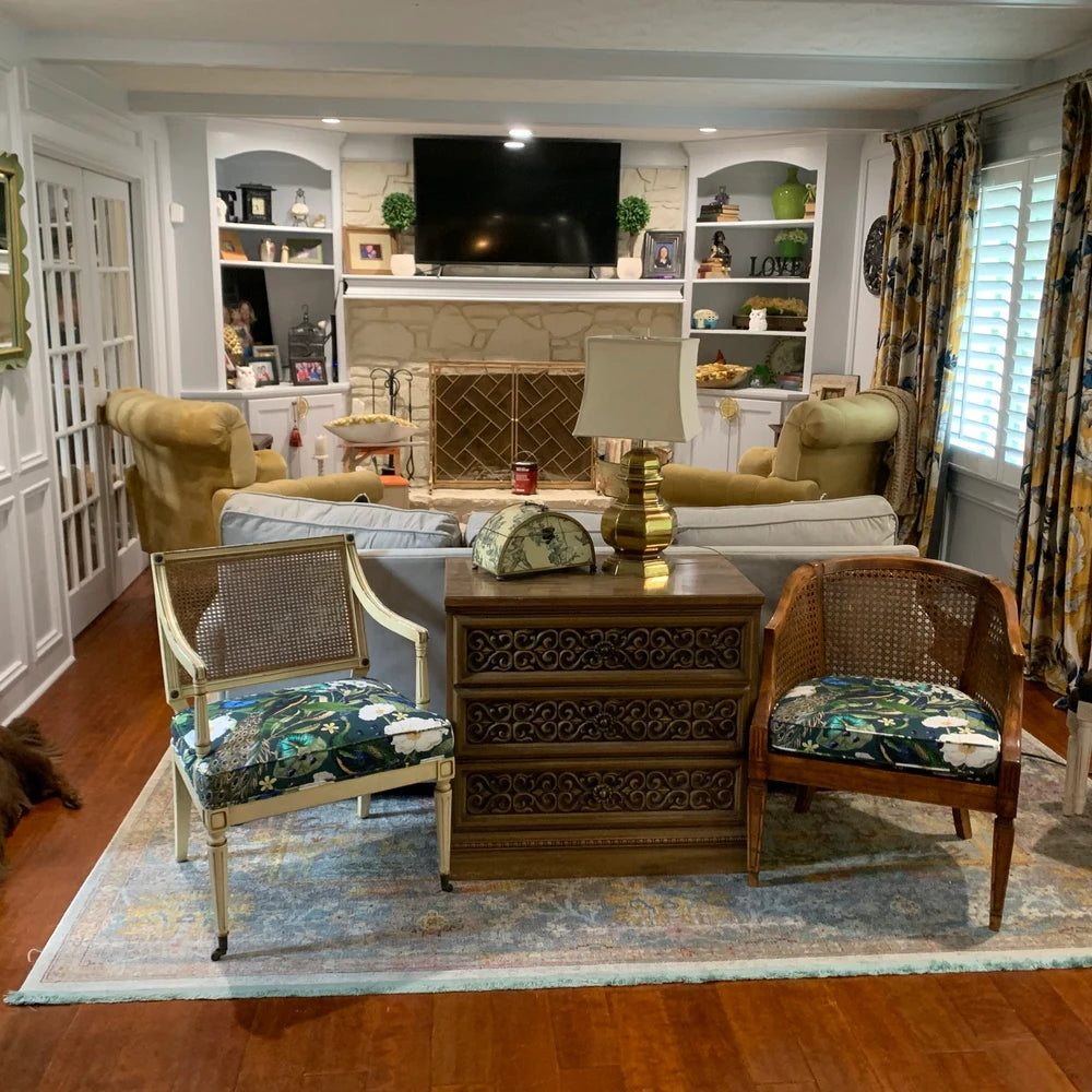 Botanical-themed chair cushions with peacock motifs.

