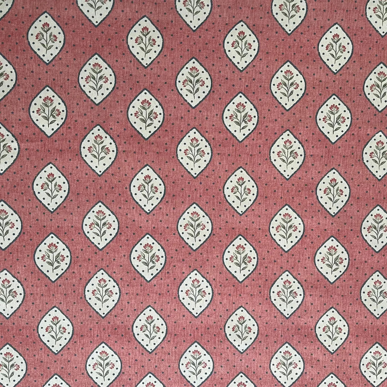 Dusty rose block print style fabric with small floral motifs