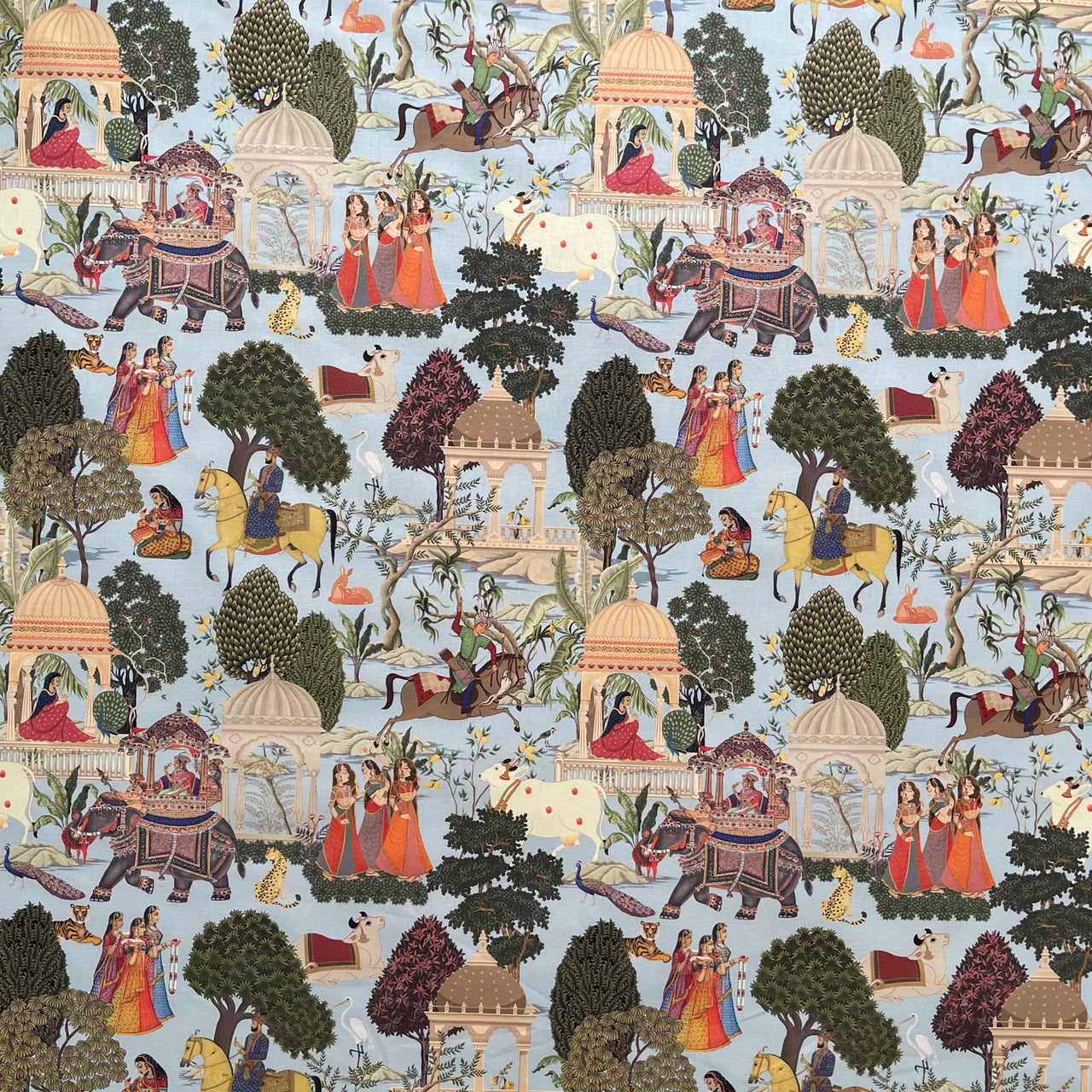 Decorative fabric with intricate patterns of people, animals, and architecture on a blue background.
