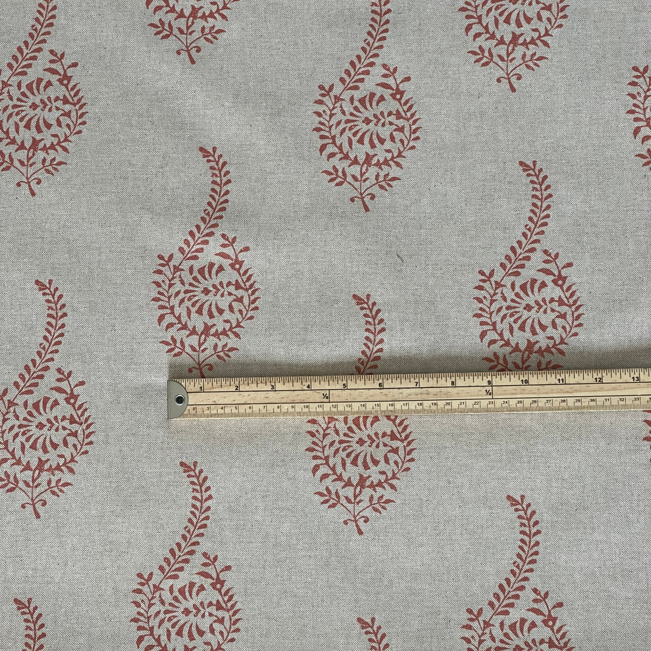 Coral paisley sprig fabric pattern on natural linen look base