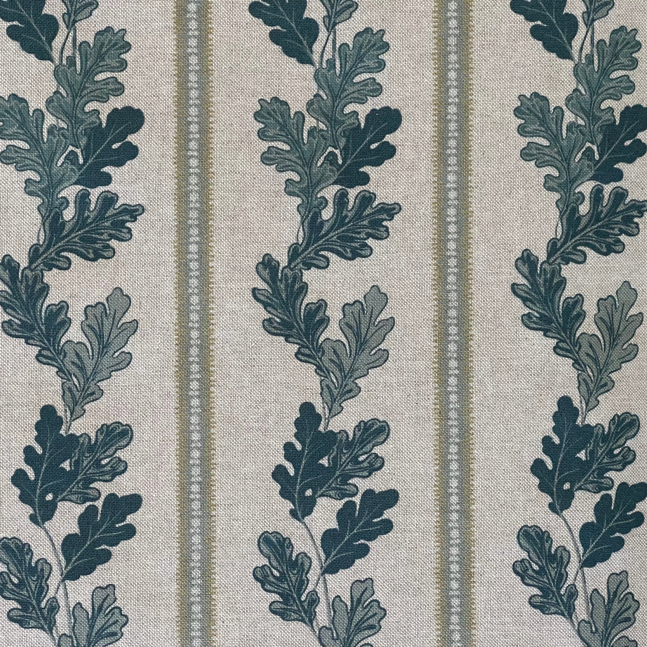 Close-up of cotton linen fabric with oak leaves and indigo stripes for home décor