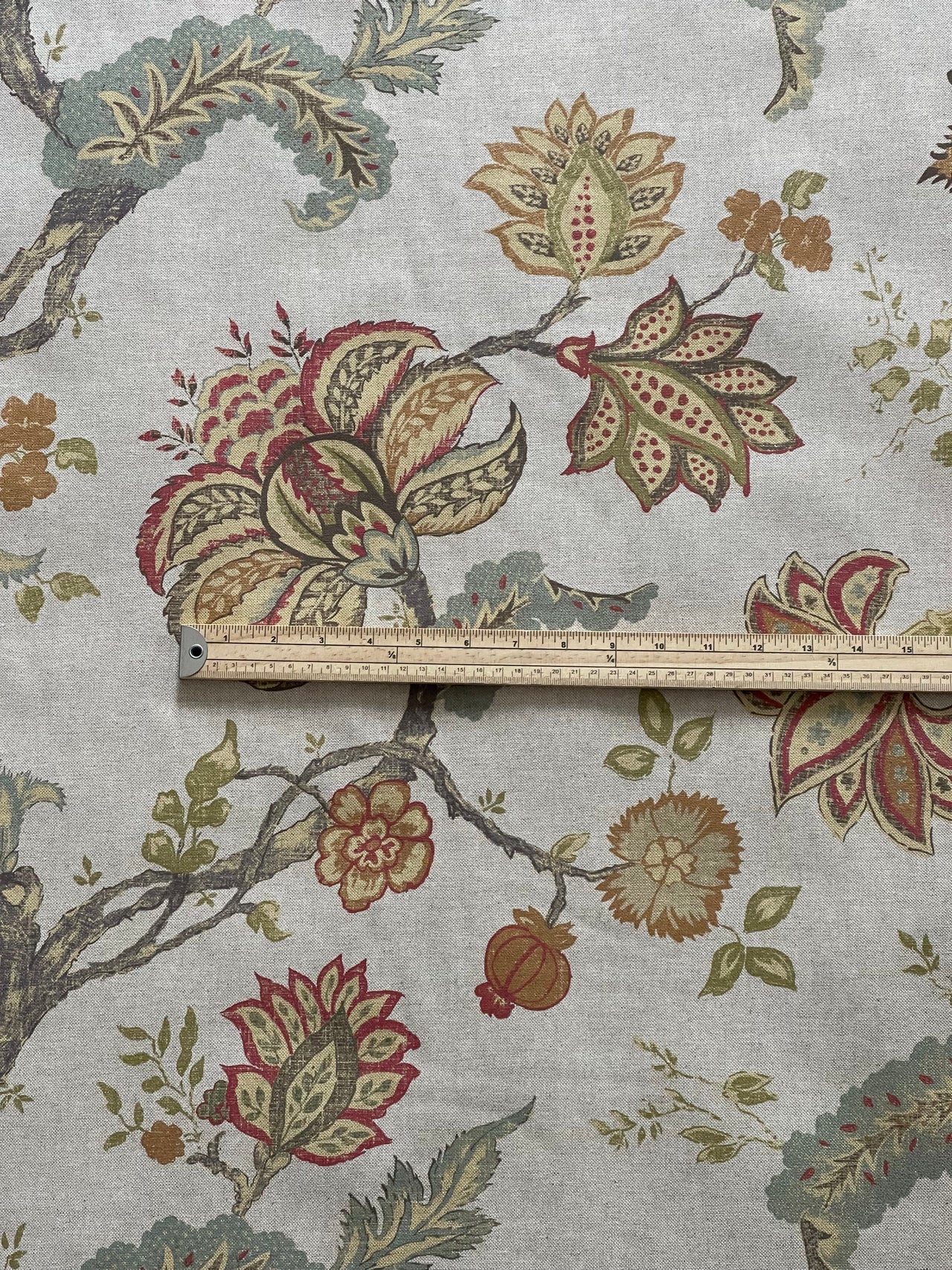 Floral patterned fabric with a ruler for scale on a light gray background